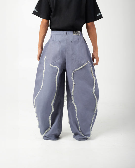 Back view of ONGNA AABELI Pants featuring pleats, back pockets, leather patch and relaxed fit.