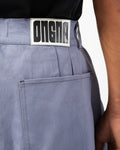 Close up of ONGNA AABELI DENIM Pants featuring leather label.