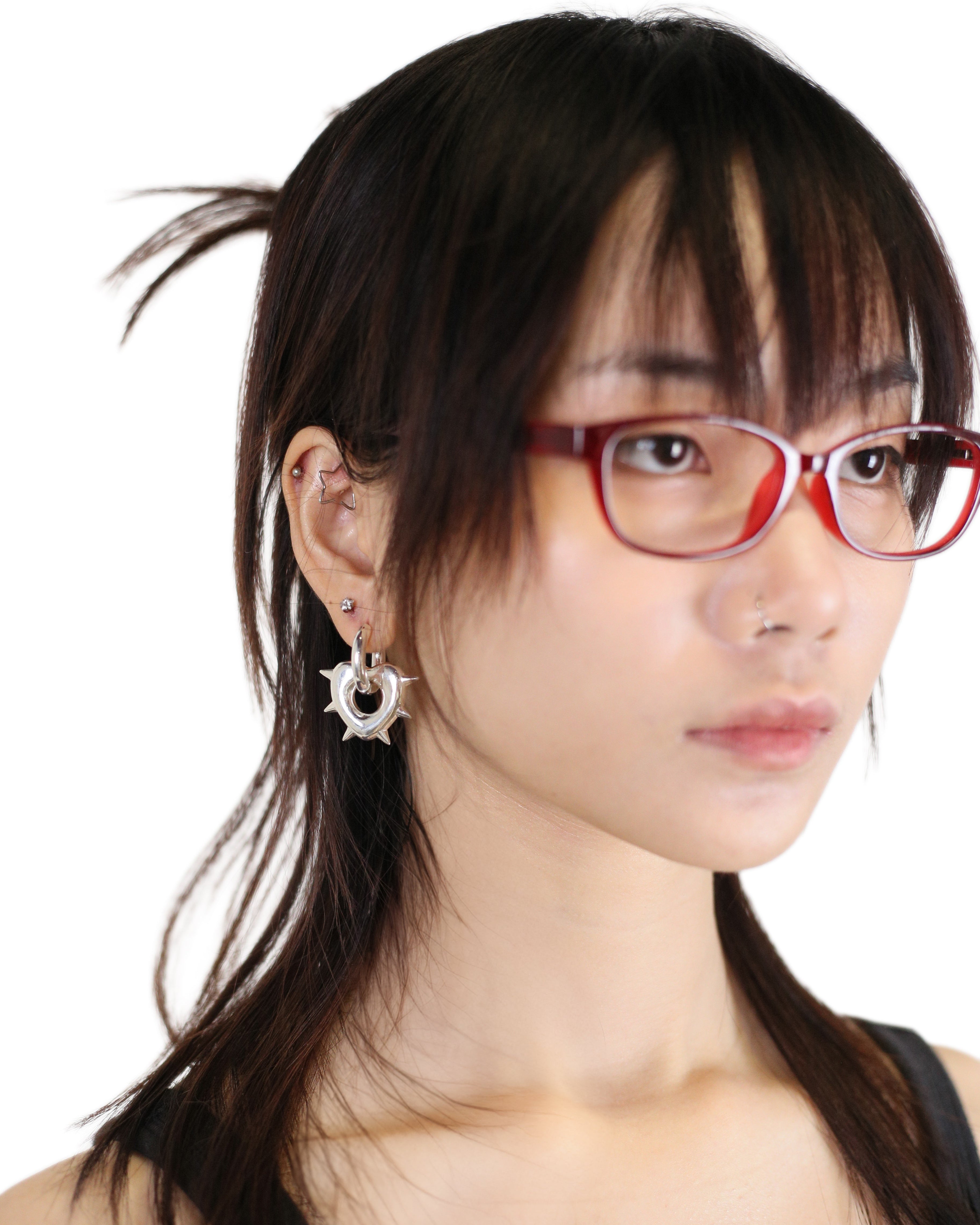 Woman wearing SILVER EARRINGS with a neutral background
