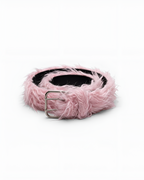 A fluffy light pink faux fur belt with a silver-tone metal buckle, coiled on a white background.